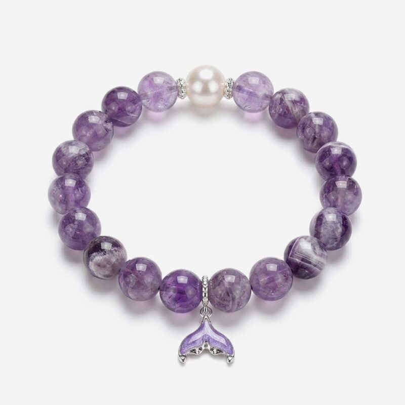 High-clarity amethyst mermaid tail bracelet showcasing 10mm chevron dream amethyst beads, a single white crystal pearl, and a purple enamel fin charm.