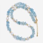 Handcrafted aquamarine chips necklace by Dewery featuring raw light-blue crystal shards and irregular white freshwater pearls with golden accent beads.