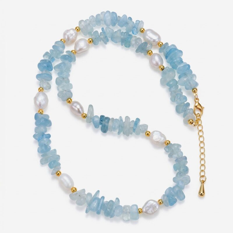 Handcrafted aquamarine chips necklace by Dewery featuring raw light-blue crystal shards and irregular white freshwater pearls with golden accent beads.