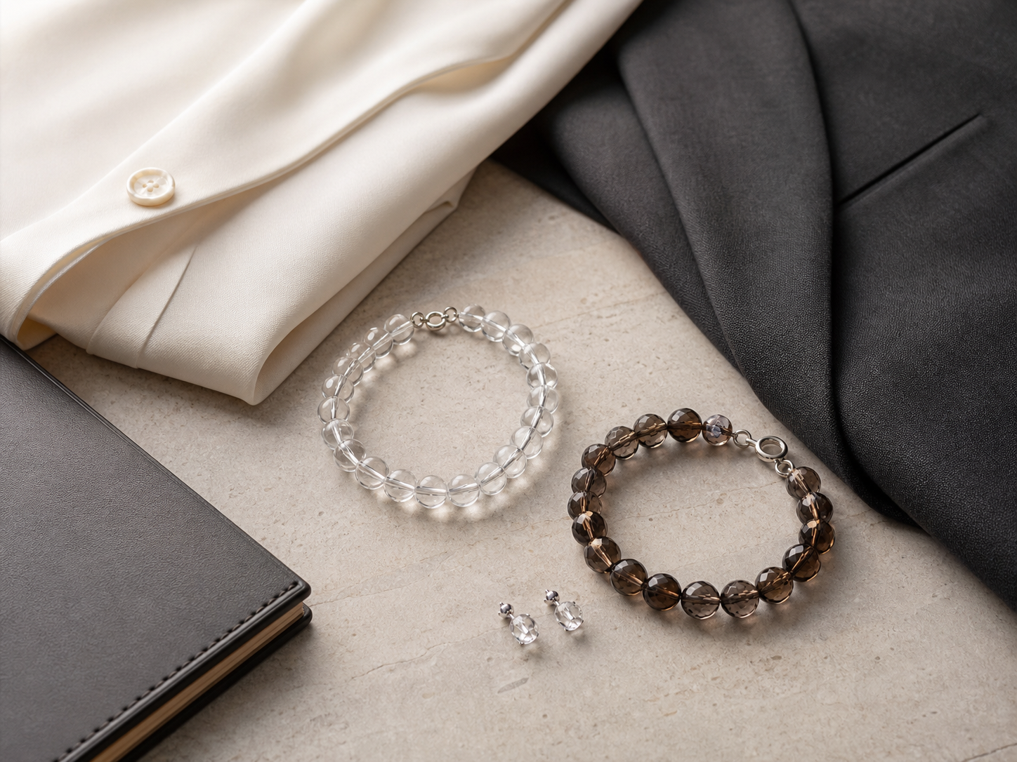 Minimalist crystal jewelry capsule with clear quartz and smoky quartz for office styling