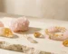 Pink and gold crystals for color therapy with rose quartz jewelry and citrine crystal meaning in a luxury minimalist studio setting