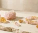 Pink and gold crystals for color therapy with rose quartz jewelry and citrine crystal meaning in a luxury minimalist studio setting